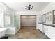 Bright Primary bathroom featuring a free-standing tub, frameless shower, and walk-in closet at 10021 Skipper Ct, Las Vegas, NV 89117