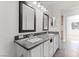 Bright bathroom featuring a granite countertop and double sinks with modern fixtures at 10021 Skipper Ct, Las Vegas, NV 89117