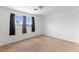 Empty bedroom with a neutral carpet, light walls, curtains, and a bright window at 10021 Skipper Ct, Las Vegas, NV 89117