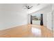 Spacious bedroom featuring wood floors, ceiling fan, and a large window with views at 10021 Skipper Ct, Las Vegas, NV 89117