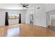 Bright bedroom with wood floors, ceiling fan, and large windows allowing for natural light at 10021 Skipper Ct, Las Vegas, NV 89117