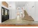 Stunning foyer with staircase, tiled flooring, and stained-glass accents at 10021 Skipper Ct, Las Vegas, NV 89117