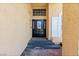 Inviting front entry with a black door, glass accents, a stylish light fixture, and brick steps at 10021 Skipper Ct, Las Vegas, NV 89117