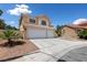 Inviting two-story home featuring a three-car garage and well-maintained front yard landscaping at 10021 Skipper Ct, Las Vegas, NV 89117