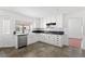 Bright kitchen features white cabinetry, tiled floors, stainless steel appliances, and granite countertops at 10021 Skipper Ct, Las Vegas, NV 89117