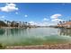 Beautiful lake view showcasing waterfront homes, lush greenery, and clear skies, perfect for a peaceful setting at 10021 Skipper Ct, Las Vegas, NV 89117