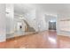 Bright living room showcasing hardwood floors, chandelier, fireplace, and open staircase at 10021 Skipper Ct, Las Vegas, NV 89117
