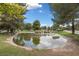 View of a peaceful pond surrounded by lush trees and clear skies at 10021 Skipper Ct, Las Vegas, NV 89117