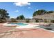 Inviting backyard featuring a refreshing pool, a relaxing patio swing, and ample space for outdoor enjoyment at 10021 Skipper Ct, Las Vegas, NV 89117