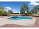 Inviting backyard featuring a pool with spa, set in a serene landscape with mature trees, perfect for relaxation at 10021 Skipper Ct, Las Vegas, NV 89117