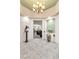 Open foyer with tiled floor, decorative art, and views into the living and dining areas at 10024 Scenic Walk Ave, Las Vegas, NV 89149