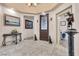 Inviting foyer with tiled floor, decorative statues, and dark wood front door with glass at 10024 Scenic Walk Ave, Las Vegas, NV 89149
