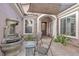 Covered patio with stone accents, tiled floor, water feature, and comfortable seating at 10024 Scenic Walk Ave, Las Vegas, NV 89149