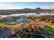 Expansive aerial view showcasing the home, golf course, mountains, and lake in the background at 15 Rue Du Rivoli Pl, Henderson, NV 89011