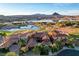 Breathtaking aerial view of the home, neighborhood, golf course, mountains and lake in the background at 15 Rue Du Rivoli Pl, Henderson, NV 89011
