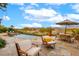 Picturesque backyard with a sparkling pool, comfortable seating, and scenic golf course views, perfect for relaxing at 15 Rue Du Rivoli Pl, Henderson, NV 89011