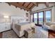 This bedroom offers wood beam ceilings, a private balcony with views, and warm natural light at 15 Rue Du Rivoli Pl, Henderson, NV 89011