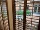 Inviting courtyard view seen through wood shutters and showing patio furniture and manicured plants at 15 Rue Du Rivoli Pl, Henderson, NV 89011