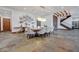 Spacious dining room featuring stone floors, a large table with seating, and elegant chandelier lighting at 15 Rue Du Rivoli Pl, Henderson, NV 89011