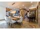 Elegant dining room with stone accents, statement chandelier, piano, and open access to multiple living spaces at 15 Rue Du Rivoli Pl, Henderson, NV 89011