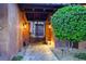 Charming front entrance featuring an ornate iron gate, brick walkway, and lush landscaping at 15 Rue Du Rivoli Pl, Henderson, NV 89011