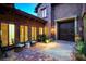 Inviting front porch with brick flooring, comfortable seating, and elegant lighting fixtures at 15 Rue Du Rivoli Pl, Henderson, NV 89011