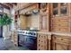 Close-up of custom wood cabinetry, built in appliances, chef's range and storage details in gourmet kitchen at 15 Rue Du Rivoli Pl, Henderson, NV 89011