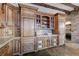 Spacious kitchen featuring custom wood cabinetry, stone countertops, and tile flooring at 15 Rue Du Rivoli Pl, Henderson, NV 89011