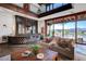 Living room showcasing a stone wet bar, comfortable seating, and views of the outside patio at 15 Rue Du Rivoli Pl, Henderson, NV 89011