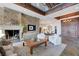 Open-concept living area with fireplace, cozy armchairs, wood accents, and seamless flow to the dining area at 15 Rue Du Rivoli Pl, Henderson, NV 89011