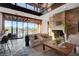 Bright living room with fireplace, comfortable seating, wet bar, and expansive windows showcasing mountain scenery at 15 Rue Du Rivoli Pl, Henderson, NV 89011