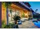 Stylish outdoor living space with comfortable seating, stone patio, and access to the pool area at 15 Rue Du Rivoli Pl, Henderson, NV 89011
