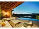 Relaxing outdoor patio with a stunning view, comfortable seating, and an infinity pool at 15 Rue Du Rivoli Pl, Henderson, NV 89011
