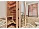 This bathroom features a private sauna, natural wood finishes, a tiled floor, and a separate toilet room at 15 Rue Du Rivoli Pl, Henderson, NV 89011