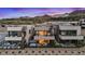Aerial view of newly constructed modern homes boasting outdoor living spaces and mountain views at 16 Heron Harbour Dr, Henderson, NV 89011