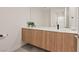 Modern bathroom vanity with wood cabinets, white countertop, and stylish fixtures at 16 Heron Harbour Dr, Henderson, NV 89011