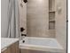 Stylish bathroom showcasing modern fixtures, a white tub, and tiled walls with built-in shelves at 16 Heron Harbour Dr, Henderson, NV 89011