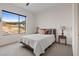 Bright bedroom featuring a cozy bed and a large window with scenic views at 16 Heron Harbour Dr, Henderson, NV 89011