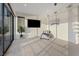 Bright bedroom with a chaise lounge, large-screen television, and sliding door to a balcony at 16 Heron Harbour Dr, Henderson, NV 89011