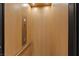 Interior view of a modern residential elevator with wood paneling and stainless steel details at 16 Heron Harbour Dr, Henderson, NV 89011