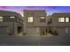 A modern home with sleek design and minimalist landscaping, illuminated by the soft glow of twilight at 16 Heron Harbour Dr, Henderson, NV 89011