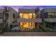 Modern home featuring a patio with hot tub and outdoor seating, with spiral staircases to upper floors at 16 Heron Harbour Dr, Henderson, NV 89011