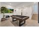 Modern game room featuring a pool table, stylish decor, and access to the staircase at 16 Heron Harbour Dr, Henderson, NV 89011