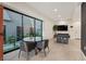 Bright game room featuring a glass table, pool table, and views of a tranquil outdoor space at 16 Heron Harbour Dr, Henderson, NV 89011