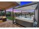Inviting hot tub under a covered area with views of the community and mountains in the distance at 16 Heron Harbour Dr, Henderson, NV 89011