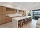 Modern kitchen featuring sleek cabinetry, a large island with seating, and stainless steel appliances at 16 Heron Harbour Dr, Henderson, NV 89011