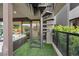Exterior spiral staircase leading to an upper level with turf grass and sliding glass doors at 16 Heron Harbour Dr, Henderson, NV 89011