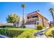 Charming two-story condo with a red tiled roof and balcony surrounded by lush greenery and palm trees at 3168 S Eastern Ave # 45, Las Vegas, NV 89169