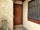 A red door with number 45 and security features, small window with bars and green plants at 3168 S Eastern Ave # 45, Las Vegas, NV 89169