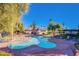 Kidney-shaped pool with lounge chairs and landscaped surroundings, perfect for relaxation and enjoyment in the community at 3168 S Eastern Ave # 45, Las Vegas, NV 89169